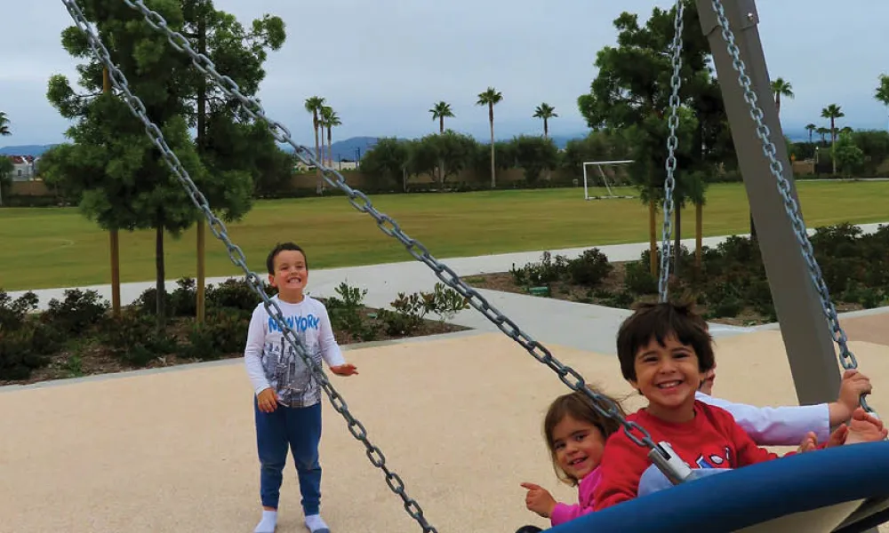Children playing on a swing
