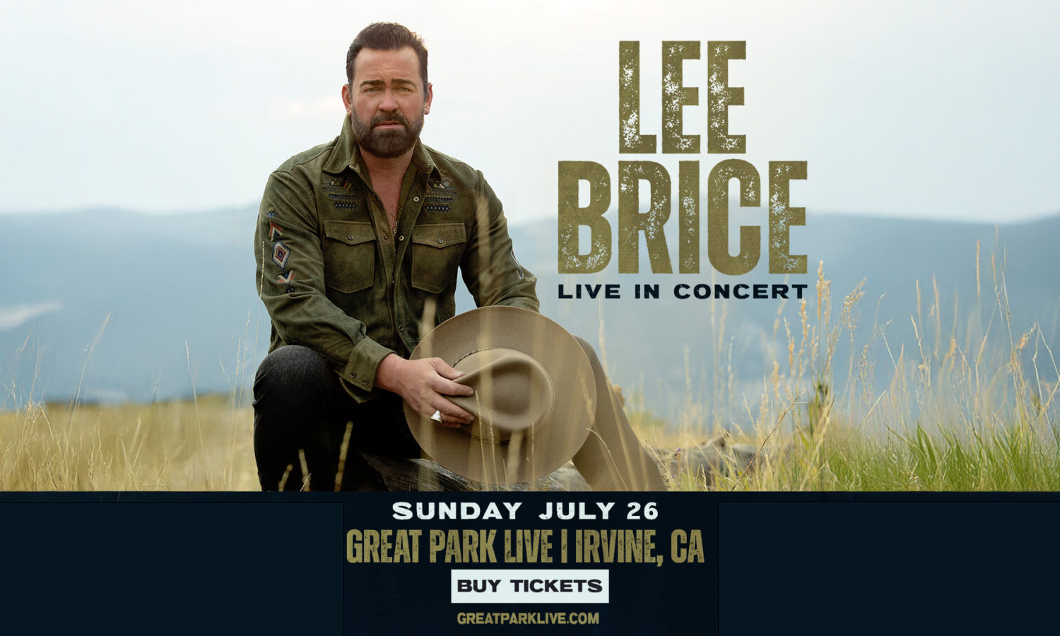 Country singer Lee Brice kneels, holding a cowboy hat in a grassy outdoor scene.