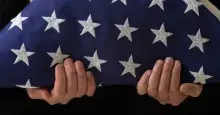 Image of person holding folded flag