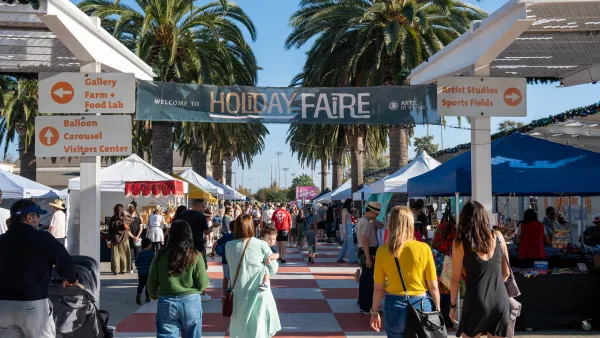 A festive outdoor Holiday Faire with crowds, stalls, a banner, and palm trees.