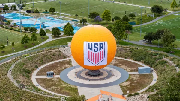 Large orange sphere with a USA logo in a recreational park.