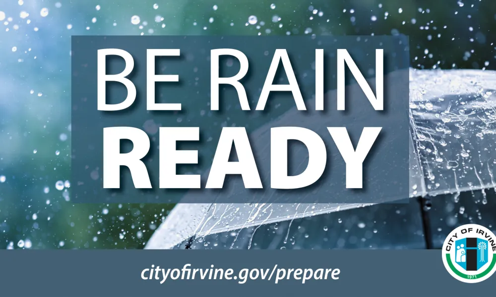 An umbrella with rain falling on it. The City of Irvine logo is in the lower right corner. In front of the umbrella are the words Be Rain Ready and at the bottom is cityofirvine.gov/prepare