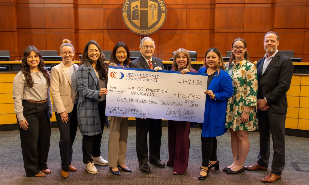 image of group of people holding a large funding check