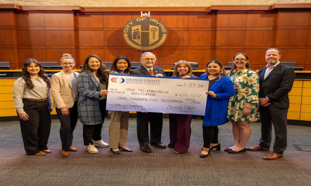 image of group of people holding a large funding check