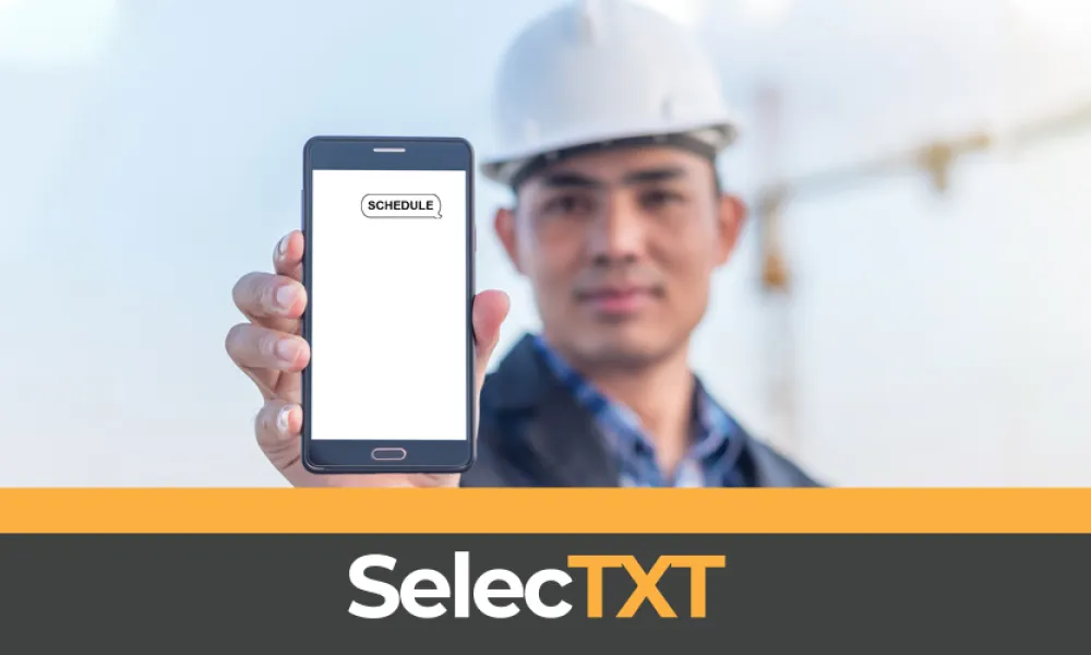 Construction worker holding up cell phone