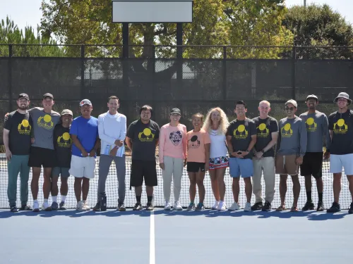 tennis coaches standing next to each other