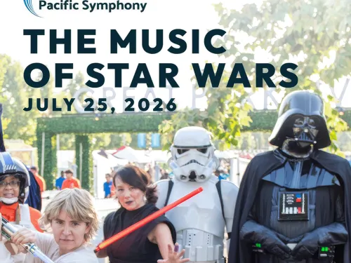 Darth Vader, Stormtrooper, and Luke cosplayers with lightsabers at an outdoor event.